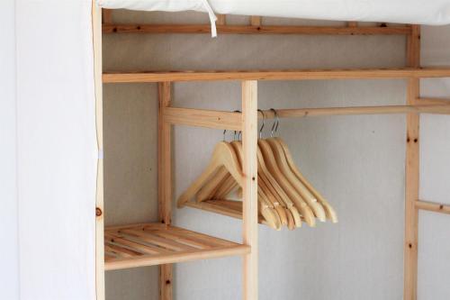 a bunk bed with wooden shelves in a room at Domek Nad Zalewem in Gołdap
