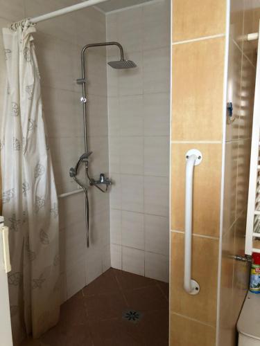 La salle de bains est pourvue d'une douche avec rideau de douche. dans l'établissement Urban CITY, à Olecko
