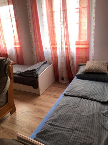 a bedroom with two beds and a window at Urban CITY in Olecko