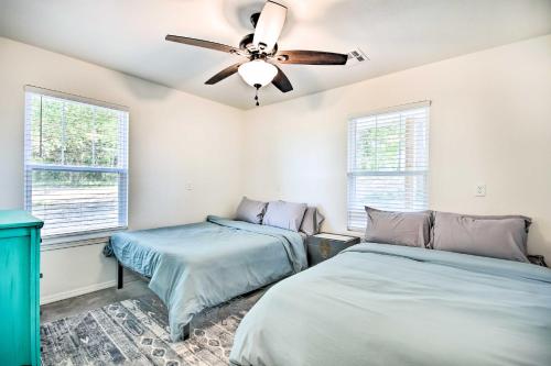a bedroom with two beds and a ceiling fan at 2 Mi to Marinas and Grove Cozy Cabin with Grill in Grove