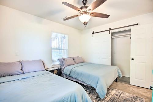 a bedroom with two beds and a ceiling fan at 2 Mi to Marinas and Grove Cozy Cabin with Grill in Grove