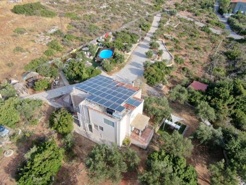 an aerial view of a house with solar panels on the roof at Ktima Nikolaos in Arónion