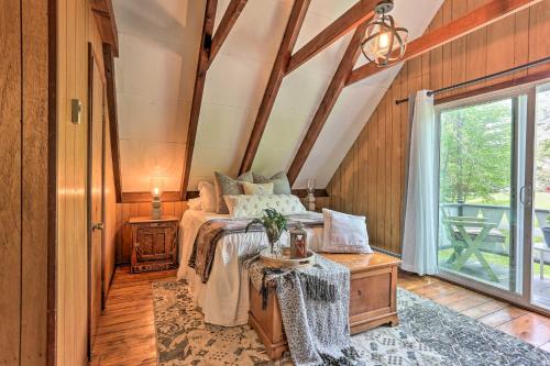 a bedroom with a bed in a room with a window at Deck and Pool Access Welcoming Poconos Retreat in Tobyhanna