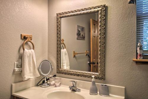 a bathroom with a sink and a mirror at Picturesque Murphy Cabin with Fire Pit and Views! in Murphy