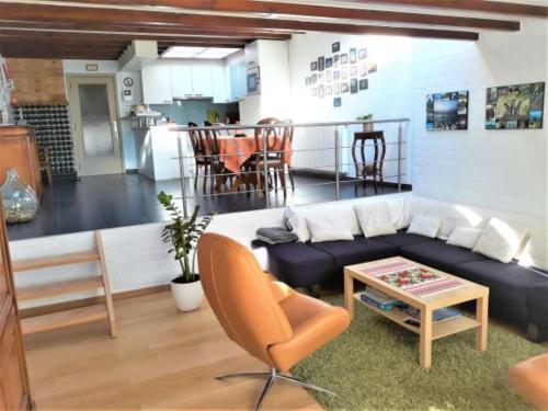 a living room with a couch and a table at Room "Carpe Diem" in Zele