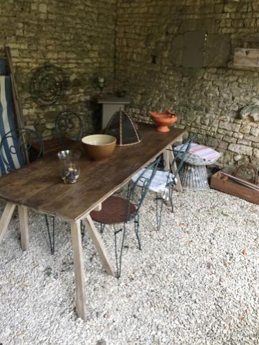 a wooden table with bowls on top of it at Fig Tree Barn in Gibourne