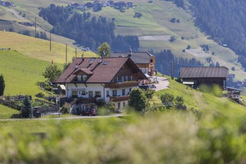 a large house on top of a hill at Haus Belodei - Apt A in San Martino in Badia