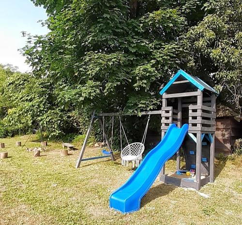 a playground with a slide and a swing at Eleonor Accommodation in Liszki