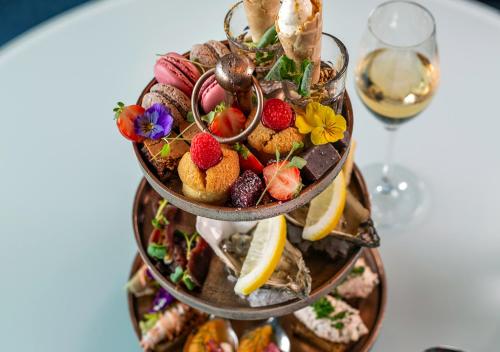 a three tiered plate of food on a table at Viking Line ferry Viking Grace - Mini-cruise from Turku in Turku