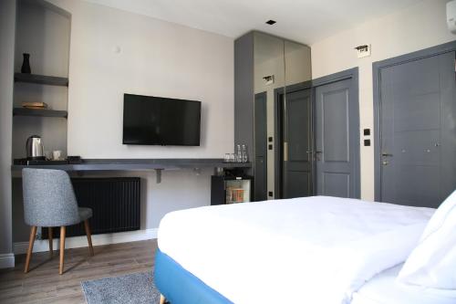 a bedroom with a bed and a flat screen tv at HOTEL BRONTE in Istanbul