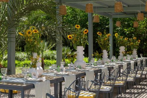 a long table set up for a party with sunflowers at Pavillon Terra Ababila en Exclusivité in Marrakech