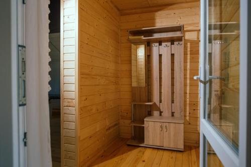 um quarto com uma sauna num chalé de madeira em Під соснами em Krivorovnya