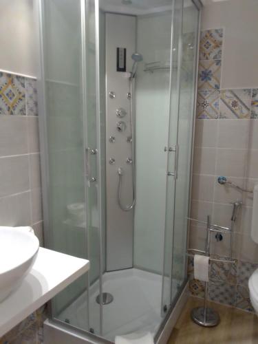 a shower with a glass door in a bathroom at DOMUS FIESCHI Rooms self check in in Genova