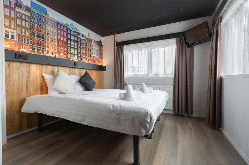 
a bedroom with a bed and a window at Botel in Amsterdam
