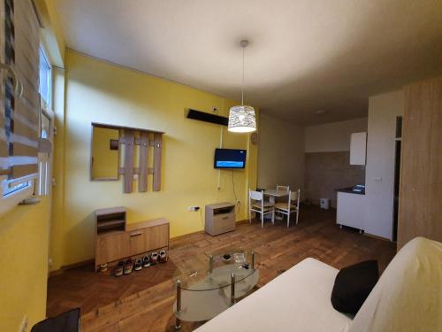 a living room with a couch and a table at Apartmani Sarti Banja Luka in Banja Luka