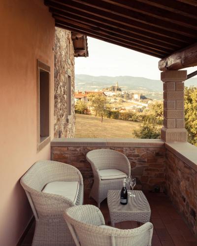 a balcony with chairs and a table with a view at Podere Cerretino in Poppi