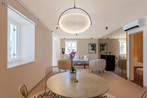 a living room with a table and chairs at Ribarska Koliba Resort in Pula
