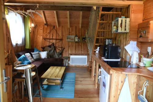 a living room and kitchen in a log cabin at Charmant chalet aux portes d'Epinal in Épinal