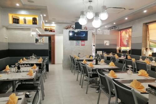 a dining room with tables and chairs and a tv at GreenColors DEPENDANCE in Campalto