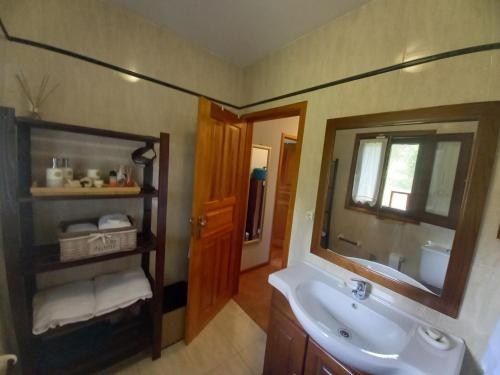 a bathroom with a sink and a mirror at Quinta do Bosque in Vagos