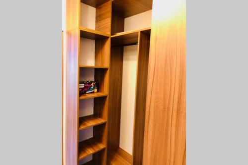 a closet with wooden shelves in a room at Joy City Stay Iasi 15 in Timişoara