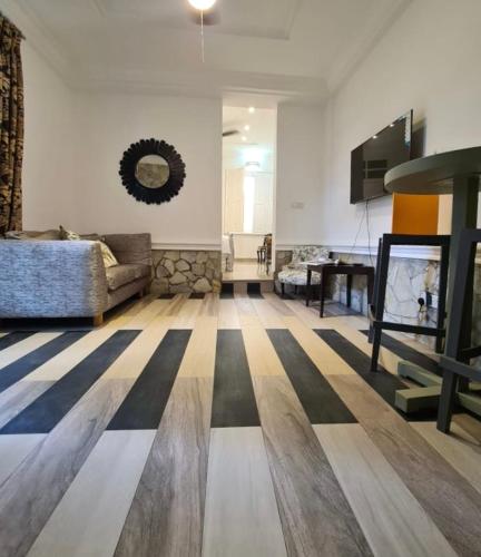 a living room with a checkered floor at Greystone Mansion in Accra