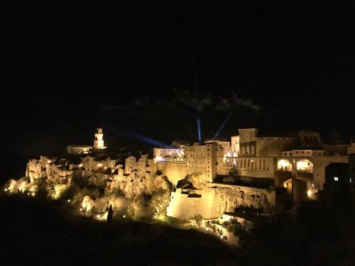 a city lit up at night with a castle at Monolocale La Mimosa in Elmo