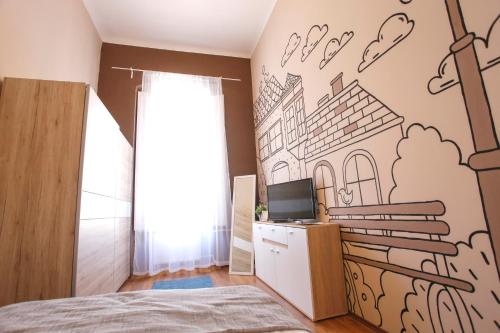 a bedroom with a wall mural of a building at Uránia Apartmanház in Eger