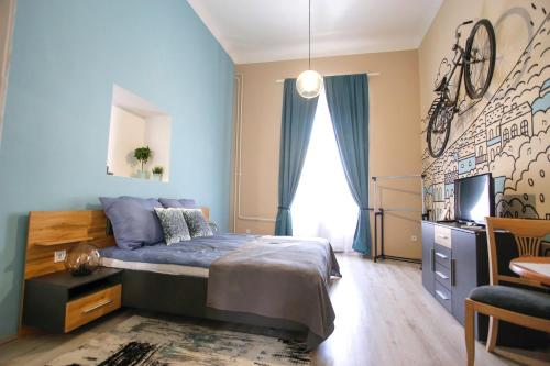 a bedroom with a bed and a tv in it at Uránia Apartmanház in Eger