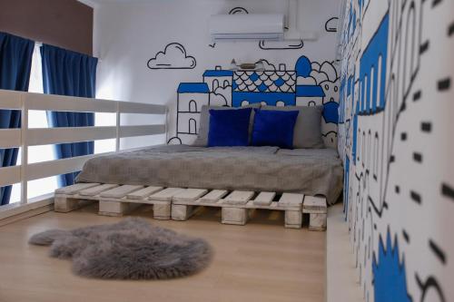 a bedroom with a bed with a bench in it at Uránia Apartmanház in Eger