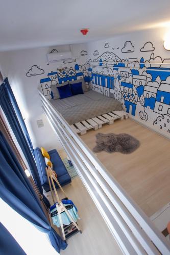 a room with a bunk bed with a mural on the wall at Uránia Apartmanház in Eger