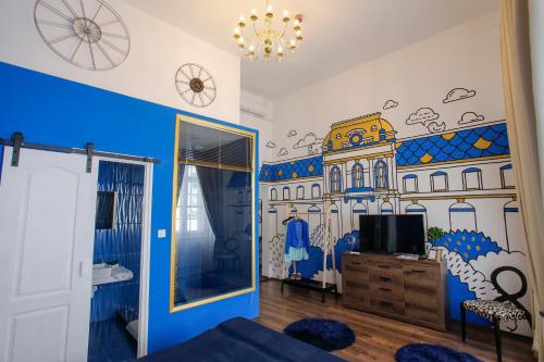 a bedroom with a mural of a building on the wall at Uránia Apartmanház in Eger