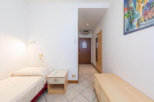 a small room with two beds and a table at Hotel New Aurora Venice in Marghera