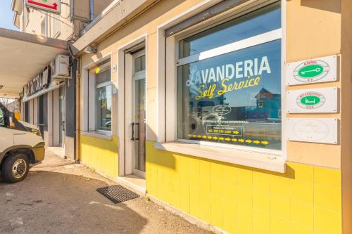 a yellow building with a sign in a window at Hotel New Aurora Venice in Marghera