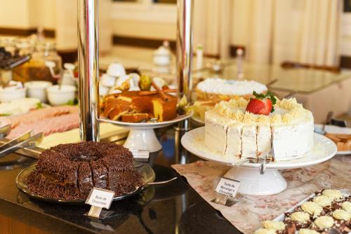 a table with cakes and other desserts on display at Hotel Kehl Haus in Gramado