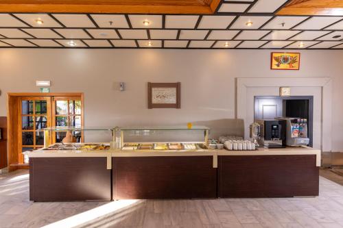 a kitchen with a counter in a room at Hotel Kathrin Beach in Adelianos Kampos