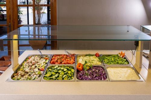 a display of different types of vegetables on a table at Hotel Kathrin Beach in Adelianos Kampos