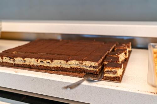 a chocolate cake is sitting in an oven at Hotel Kathrin Beach in Adelianos Kampos
