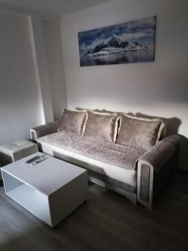a living room with a couch and a table at Apartmani Srećko in Žabljak