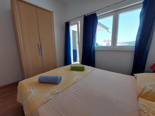 a bedroom with a bed with two towels on it at Apartment Jure in Primošten