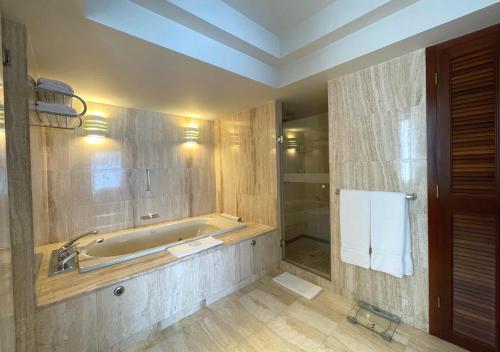 a bathroom with a bath tub and a sink at Swissotel Lima in Lima