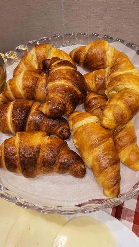 a plate of croissants and pastries on a table at Hotel Laguna Residence in Marghera