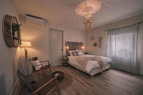 a bedroom with a bed and a chandelier at Stadshotel Weert in Weert