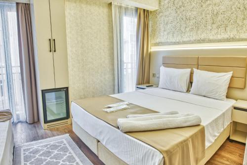 a bedroom with a large bed and a television at Florina Hotel in Istanbul