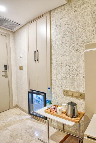a kitchen with a table with a tv on it at Florina Hotel in Istanbul