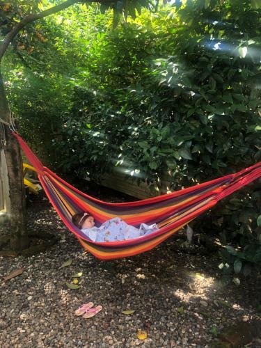 a baby is sleeping in a hammock at PAPILLON in Chakvi