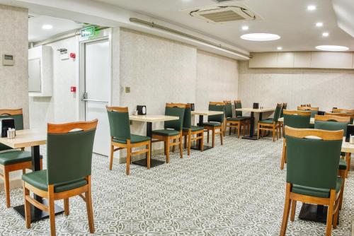 a room with tables and chairs in a classroom at Florina Hotel in Istanbul