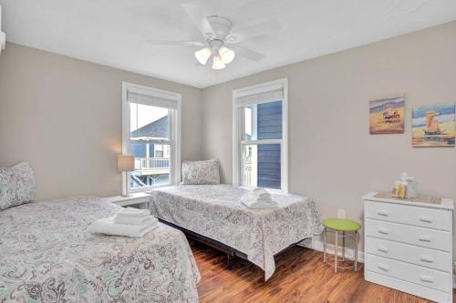 a bedroom with two beds and a ceiling fan at Odysea in Hampton