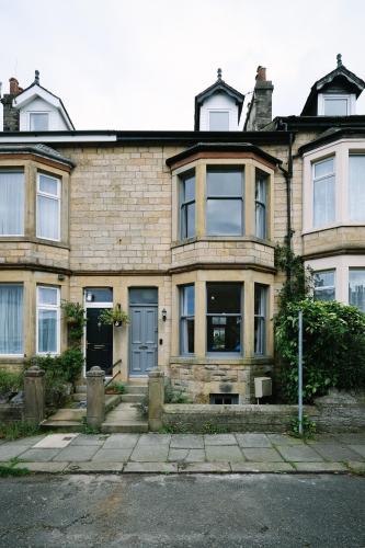 an old brick house with a blue door at Period Retreat for 6, explore the Lake District in Lancaster