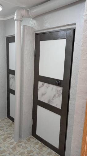 a door in a room with a pillar at Arista Yurt Camp in Karakol